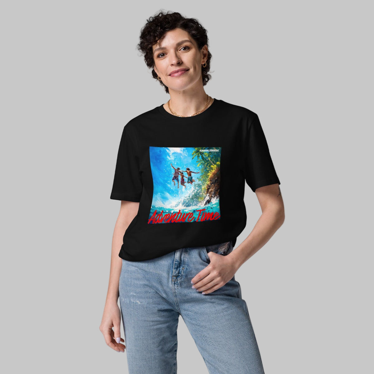 Woman wearing a black t-shirt with a 'Adventure Time' graphic design and AShamaluevMusic logo on a grey background.