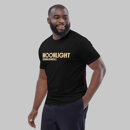 Man wearing a black organic cotton t-shirt with 'Moonlight' print and AShamaluevMusic logo on a light grey background