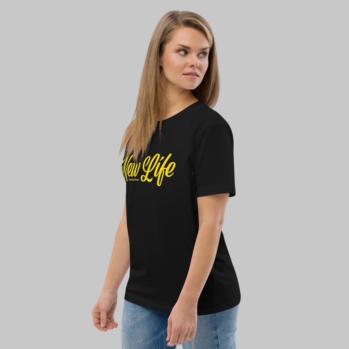 Woman wearing a black organic cotton t-shirt with 'New Life' print and AShamaluevMusic logo in yellow text on a grey background