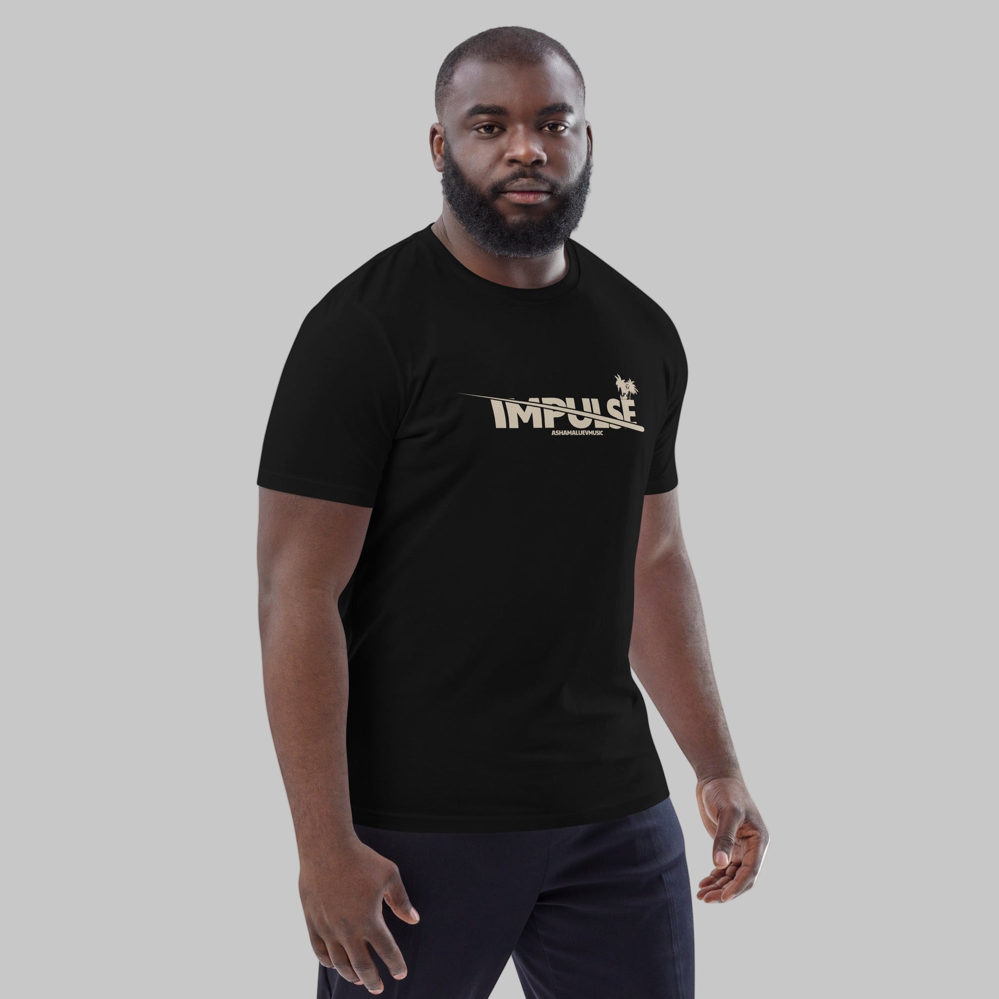 Man wearing a black t-shirt with text 'IMPULSE' and AShamaluevMusic logo on a grey background