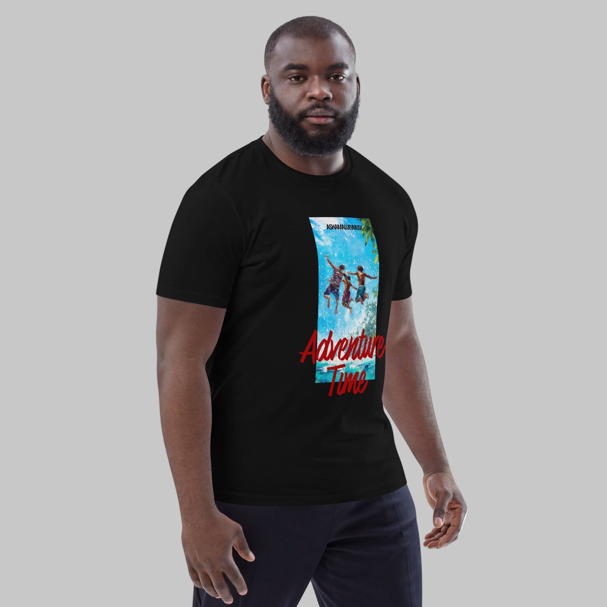 Man wearing a black t-shirt with 'Adventure Time' graphic design and AShamaluevMusic logo on a grey background.