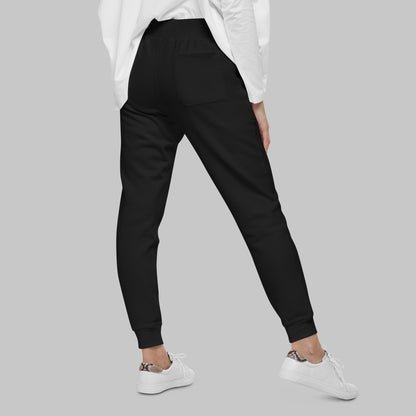 Woman wearing black fleece sweatpants on a gray background