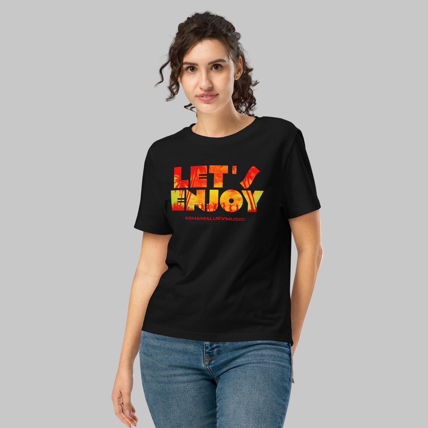 Woman wearing a black t-shirt with 'LET'S ENJOY' text and AShamaluevMusic logo in colorful letters on a grey background