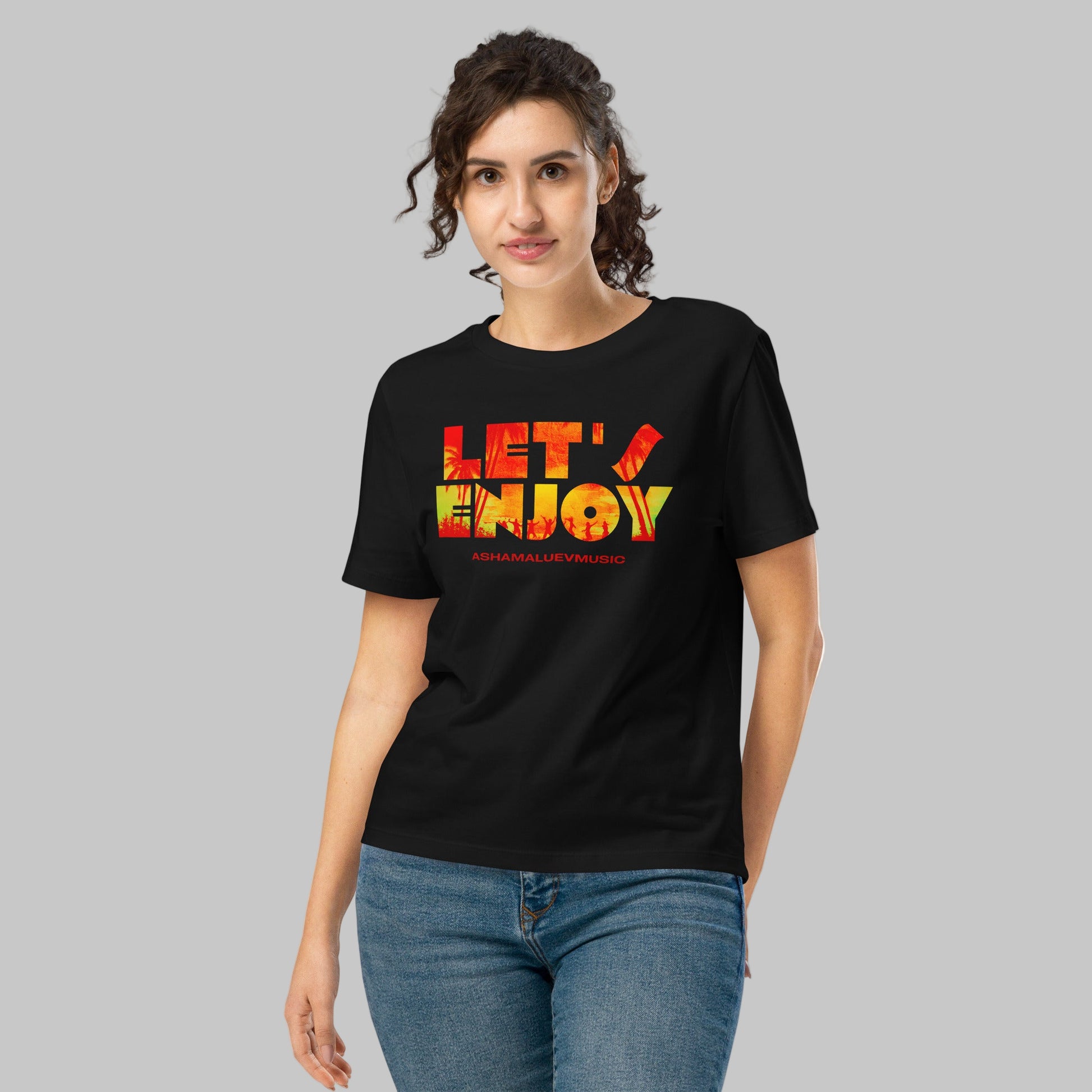 Woman wearing a black t-shirt with 'LET'S ENJOY' text and AShamaluevMusic logo in colorful letters on a grey background