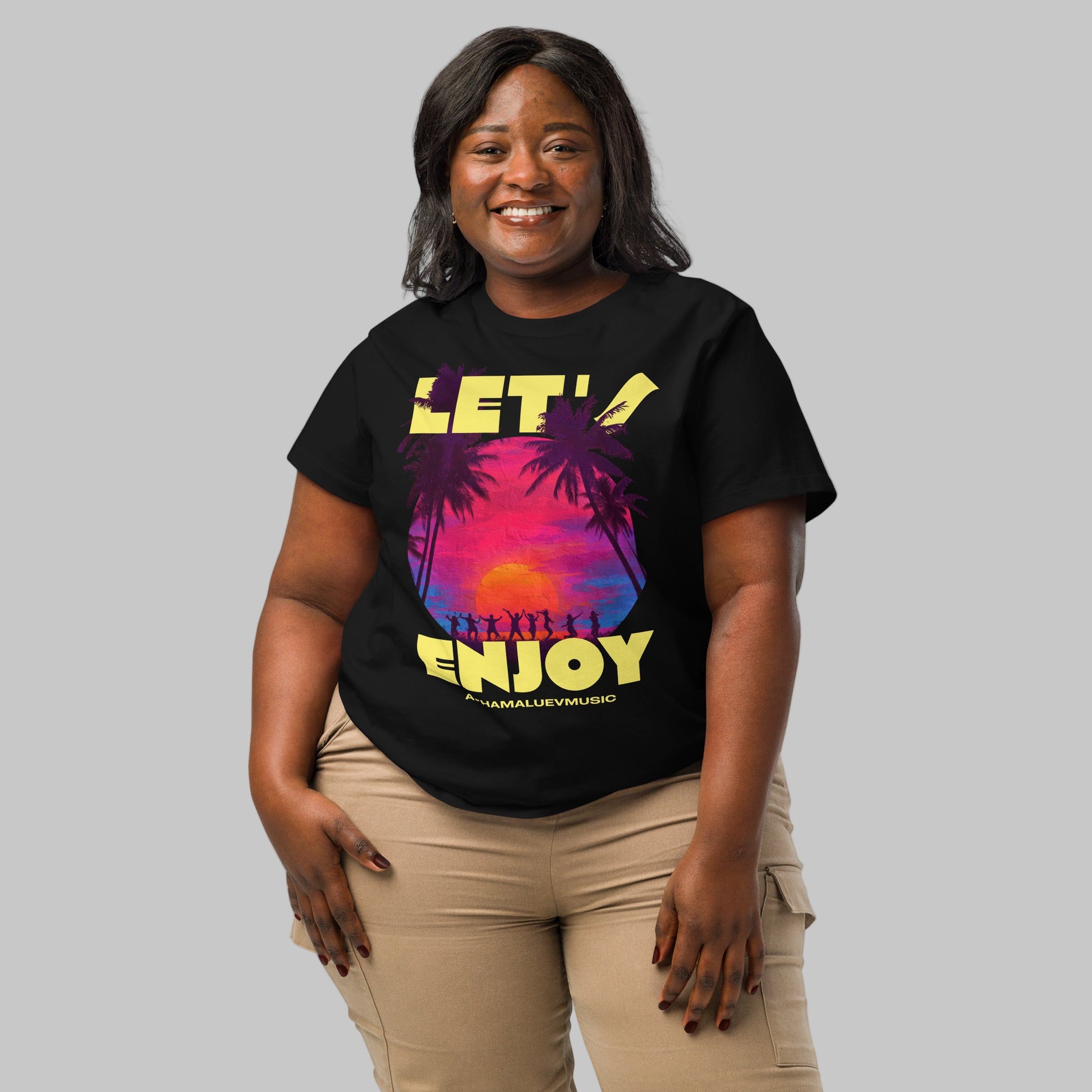 Woman wearing a black t-shirt with a Let's Enjoy print and AShamaluevMusic logo on a grey background