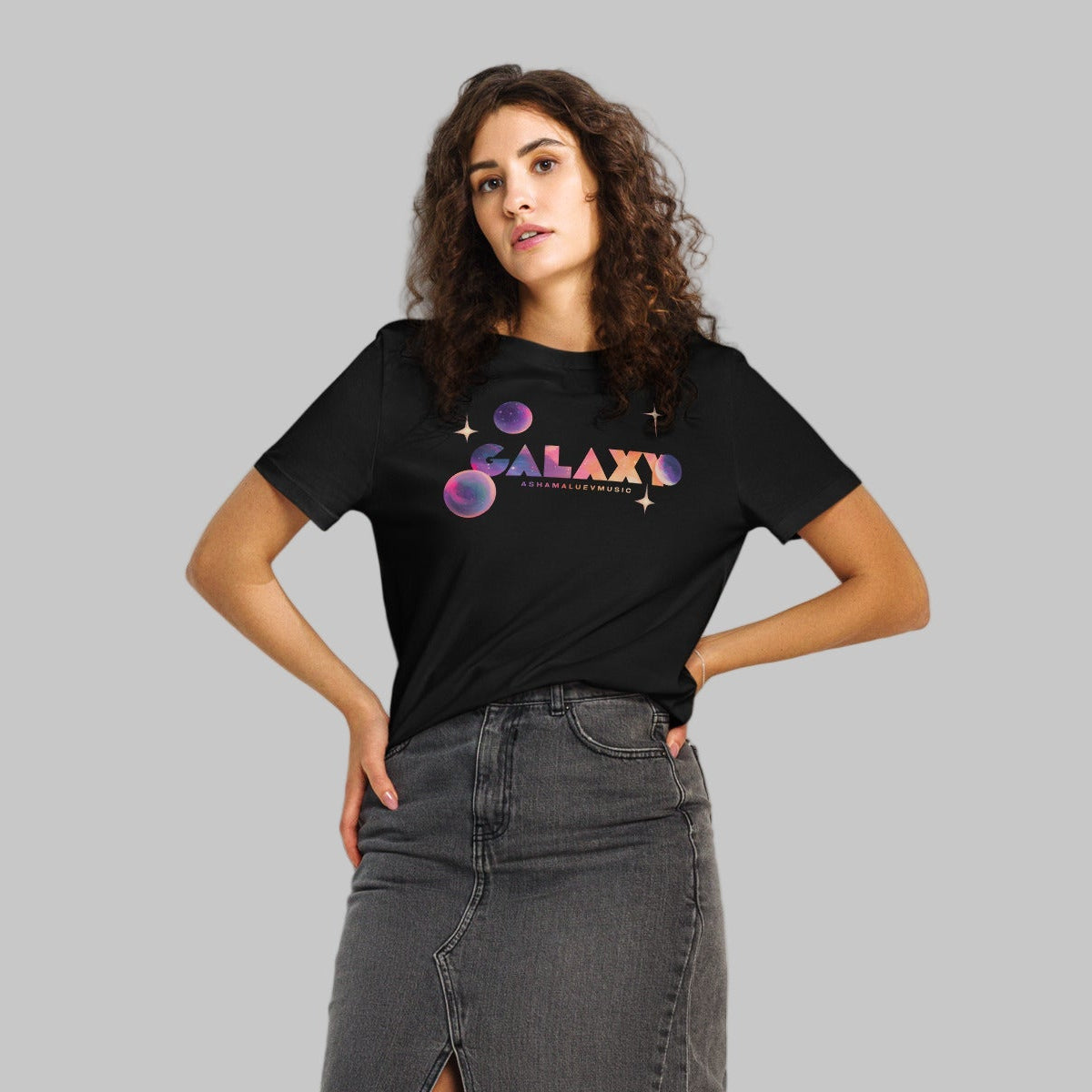Woman wearing a black t-shirt with a 'Galaxy' design and AShamaluevMusic logo on a light grey background