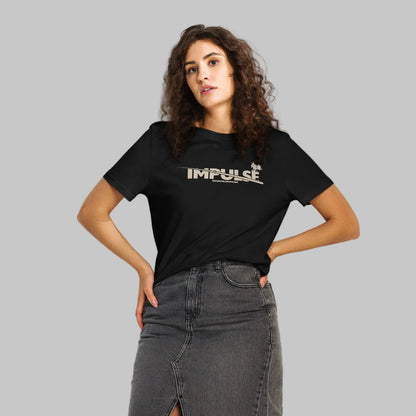 Woman wearing a black women's organic short sleeve t-shirt with beige text 'IMPULSE' and AShamaluevMusic on a gray background