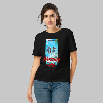 Woman wearing a black organic short sleeve t-shirt with a 'Adventure Time' colorful graphic and text 'AShanaluevMusic' on a gray background
