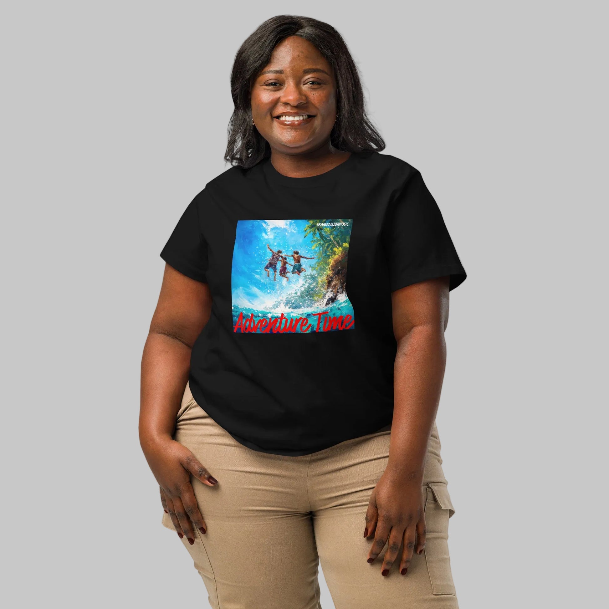 Woman wearing a black short sleeve t-shirt with a 'Adventure Time' colorful graphic and 'AShamaluevMusic' text on a gray background