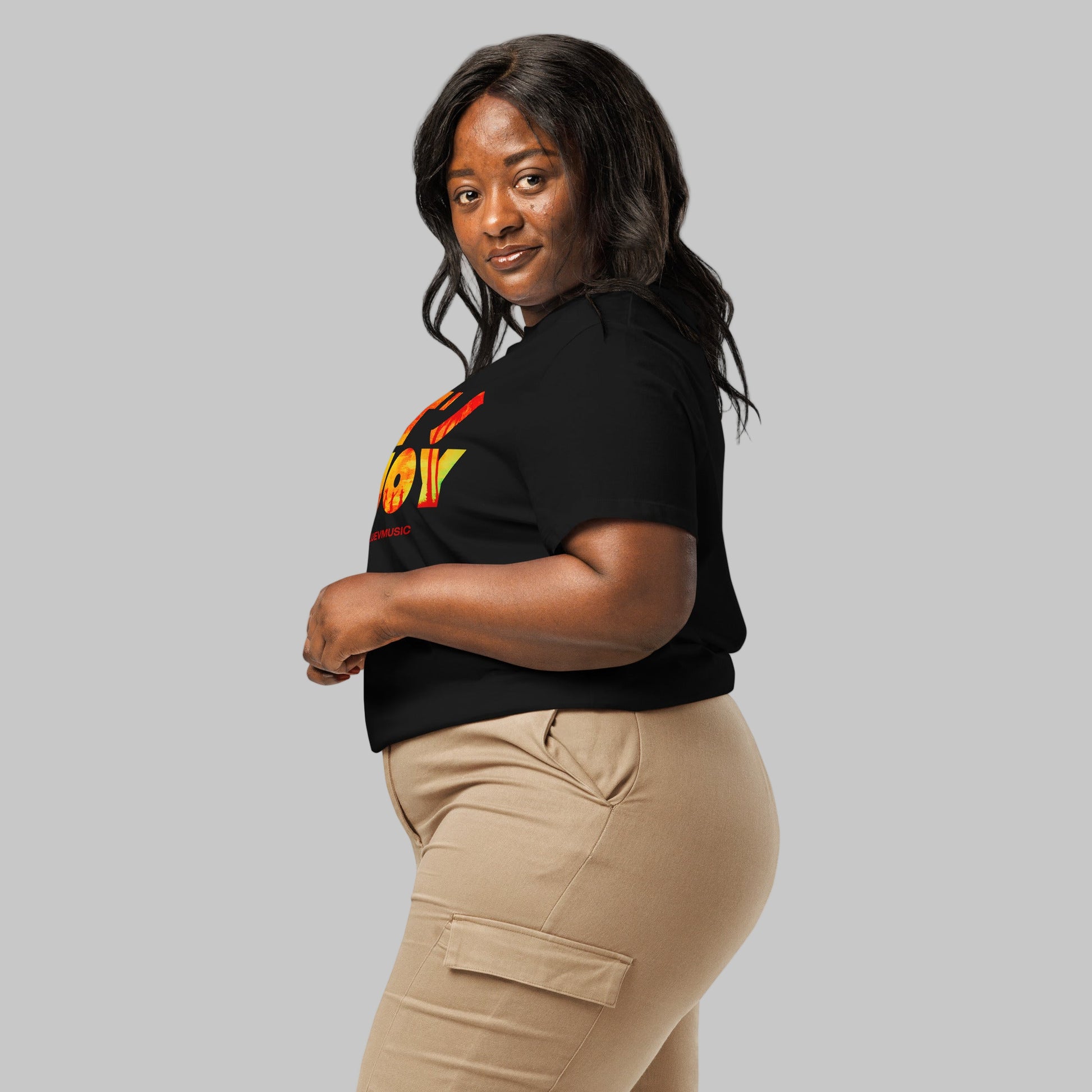 Woman wearing a black t-shirt with 'LET'S ENJOY' text and AShamaluevMusic logo in colorful letters on a grey background