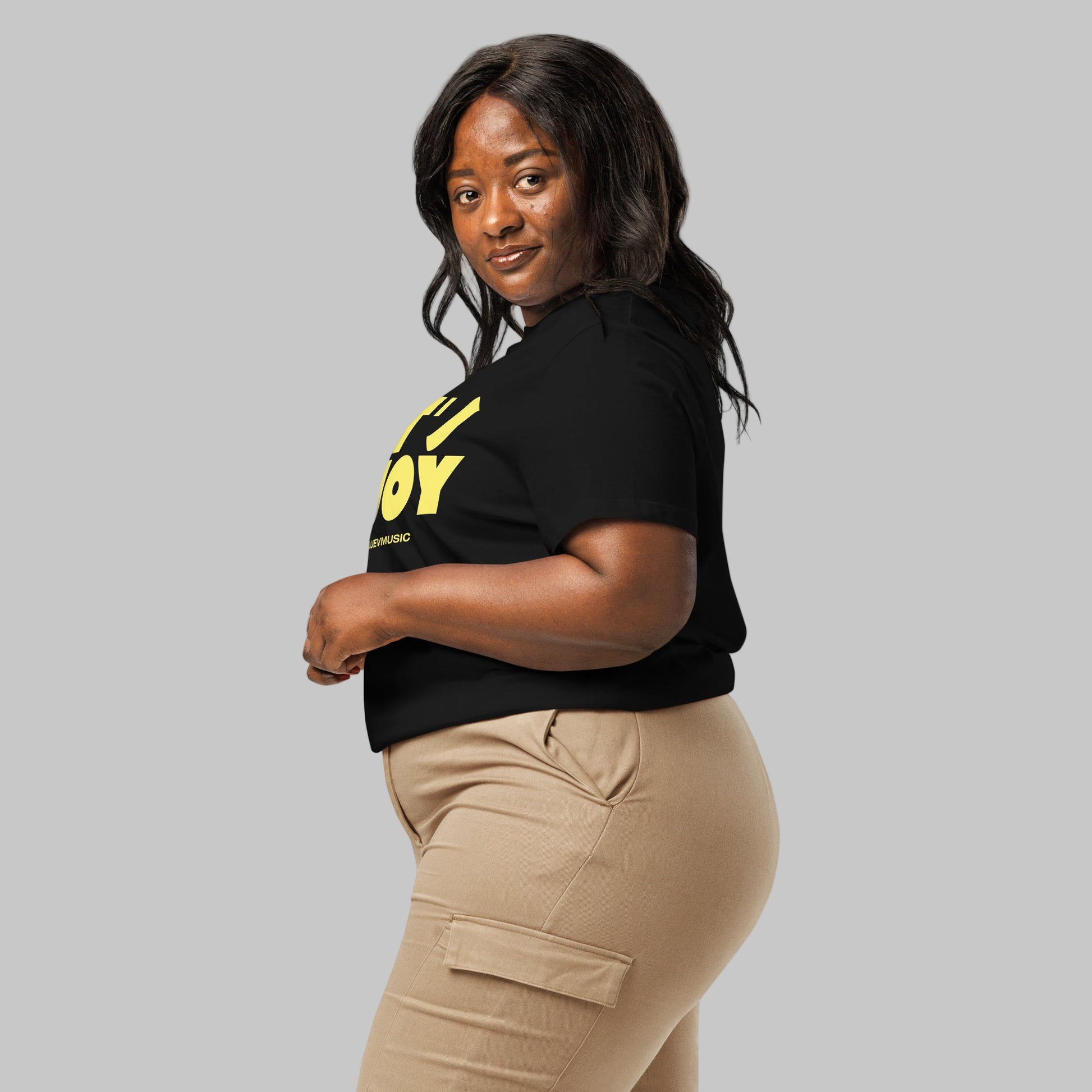 Woman wearing a black t-shirt with a 'Let's Enjoy' print and AShamaluevMusic logo on a grey background