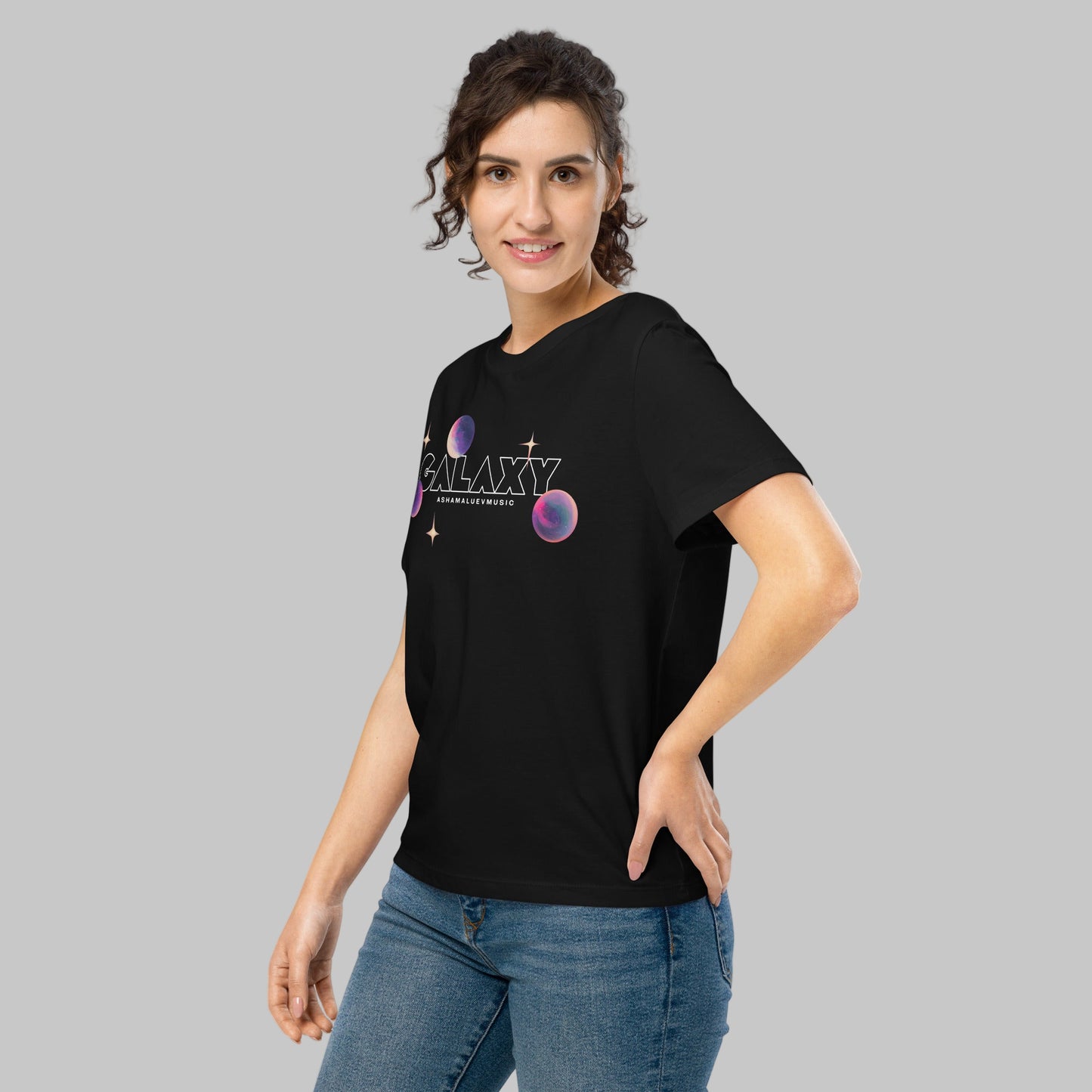 Woman wearing a black t-shirt with a 'Galaxy' design and AShamaluevMusic logo on a light grey background