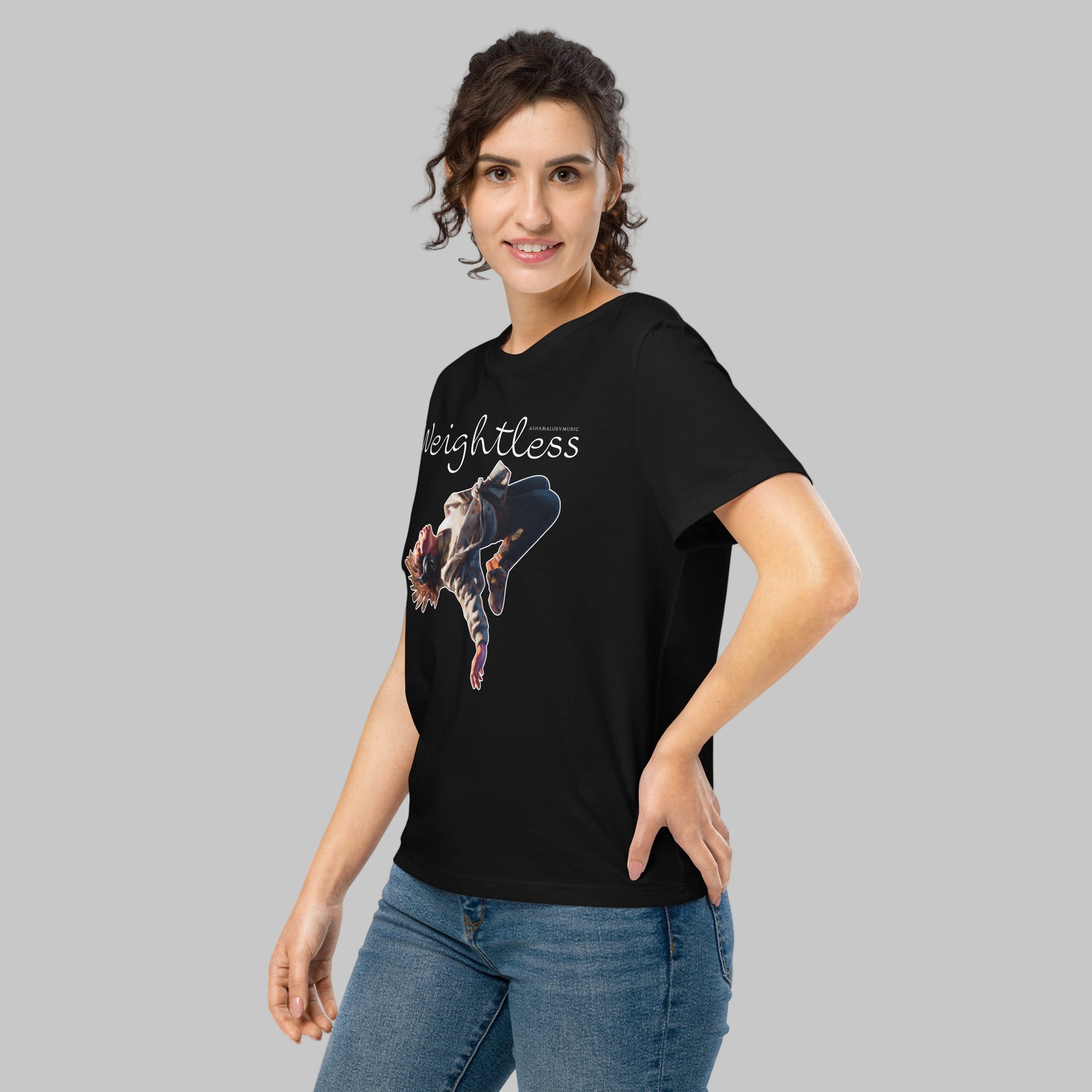 Woman wearing a black t-shirt with a 'Weightless' design and AShamaluevMusic logo on a light grey background